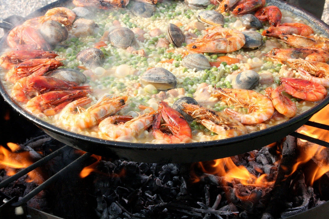 Saffron Seafood Paella on fire in steel pan